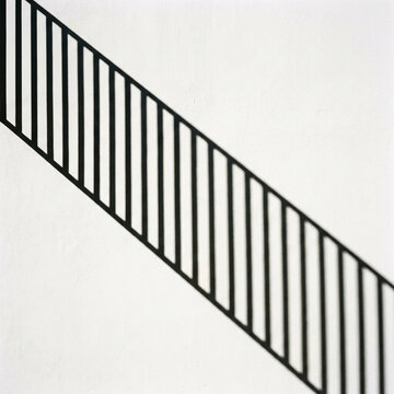 Architectural Shadow Overlay vertical railing bars casting evenly spaced shadows, shadow overlay effect for photo and poster design, window shadow texture, sunlight background, digital design resource