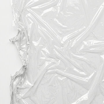 Plastic Wrap Overlay torn film with a ragged stretched edge, plastic wrap effect for photo and poster design, cellophane texture, transparent background, digital design resource for creative projects