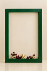 Fototapeta premium A festive green picture frame with holiday decorations wishing everyone a very happy christmas season this year