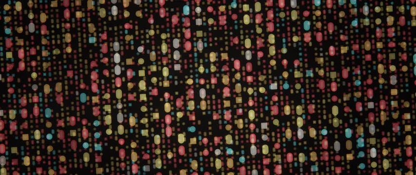 Multicolored geometric lights shimmer across a dark abstract grid in a shifting pattern