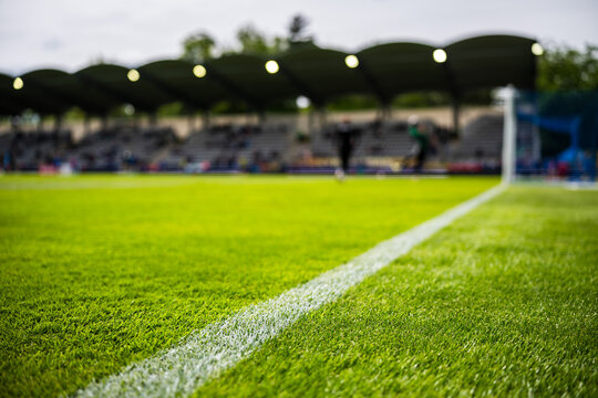 Low-angle view of soccer field grass and goal line real daylight sports environment with natural vivid colors.