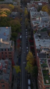 Vertical video: Tranquil Harlem Meer scenic artificial lake located in the northeastern corner of Central Park, Manhattan, New York City reflecting the cityscape