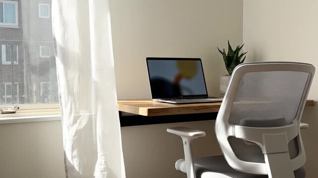 Modern home office workspace with laptop and ergonomic chair