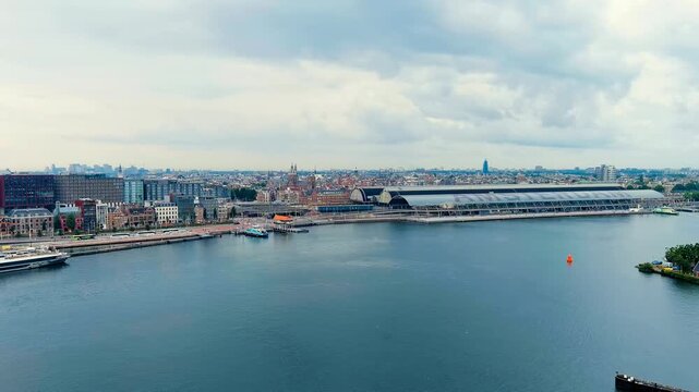 The Hague, Netherlands. Business center of The Hague. Large train station Den Haag Centraal. Cloudy weather. Summer day. Drone footage
