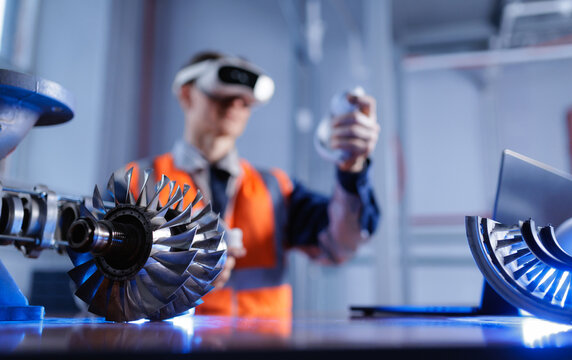Caucasian male engineer using ar technology for turbine inspection in industrial setting