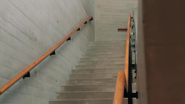 A left to right glide follows a concrete staircase before it disappears behind a foreground wall.