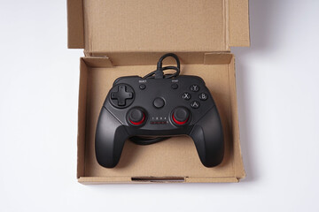 Modern Wired Game Controller for Video Games in a Weird Box © AndhikaRaya