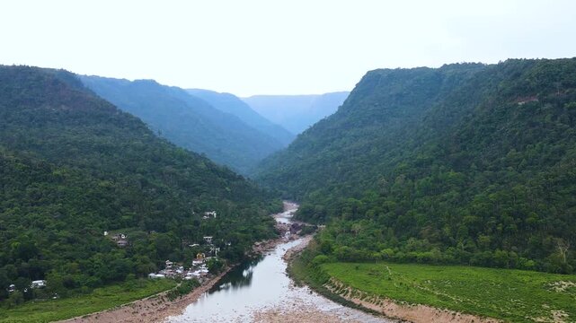 Dry river go through border hills alongside indigenous settlement in Sylhet., Bangladesh india border - aerial.