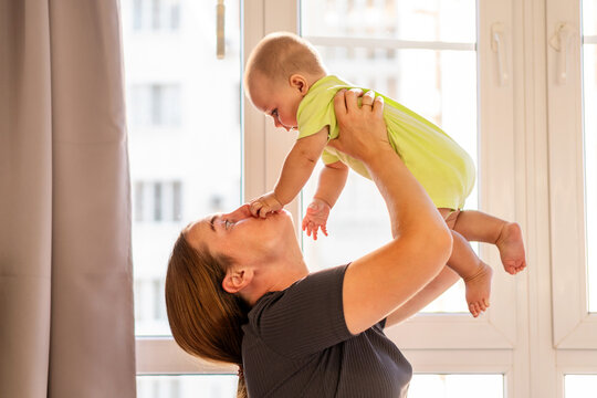 Baby Boy Touches Mother&rsquo;s Nose During Playful Lift