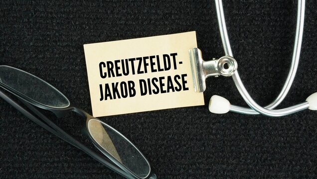 Stethoscope and paper with the words Creutzfeldt-Jakob disease CJD is a rare, rapidly progressive, and fatal neurodegenerative brain disorder caused by abnormal infectious proteins called prions