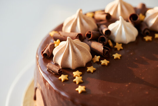 Chocolate cake with meringue peaks and gold star decorations