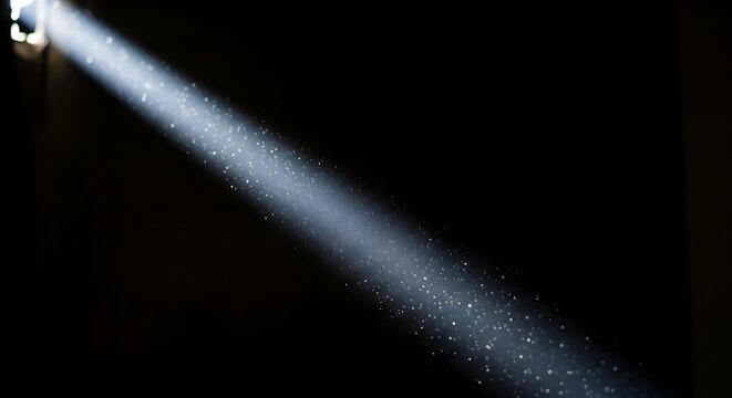 Sunbeam illuminating dust particles in dark room with selective focus creating atmospheric mood and depth