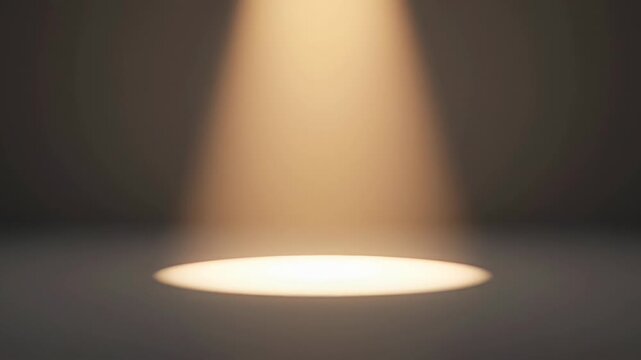 Single warm spotlight illuminating a dark gray floor and background