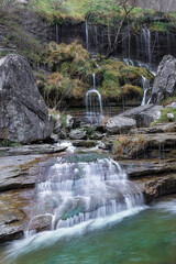 Long exposure shot of small waterfalls cascading over mossy rocks at the source of the Nervion river in Delika canyon, Alava, Basque Country, Spain © patxi