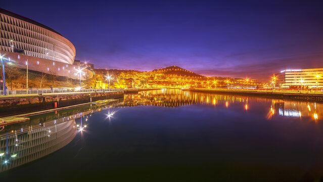 Bilbao, Spain, October 2026, Night view of San Mames stadium and the estuary with illuminations and city reflections