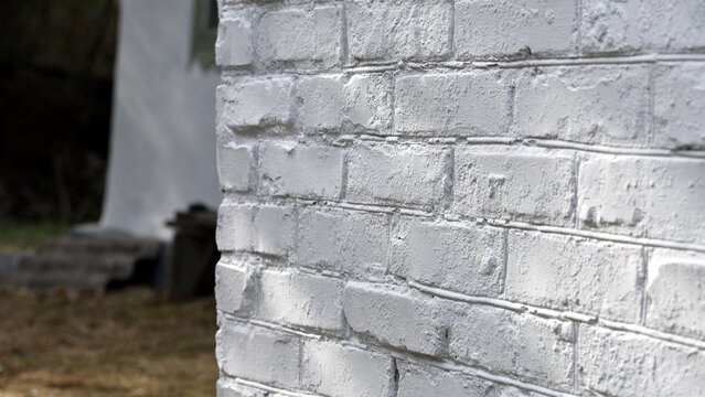 background, brick wall painted white. brick wall facade texture. old bricks in an exterior uneven wall of a house. masonry, construction, repair, restoration. space for text