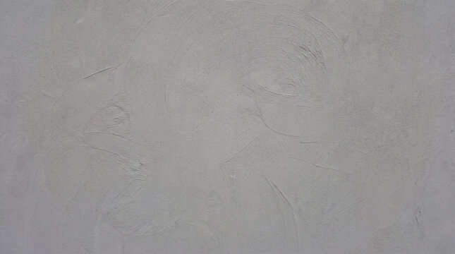 Smooth grey microcement wall with soft trowel marks seen straight on