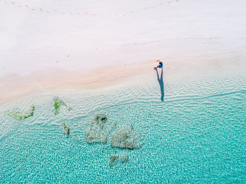 Man walking at the beach. clear water. summer.