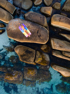 Girl on Rock by the Ocean