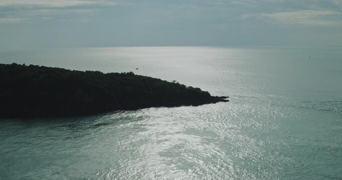 Forested Tropical Headland Surrounded by Shimmering Sea in Phu Quoc