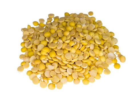 Heap of raw yellow split peas on a clean white surface