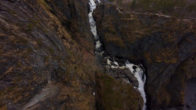 FPV drone flies above Voringfossen, revealing the valley, bridge and two waterfalls before heading out into the gorge.