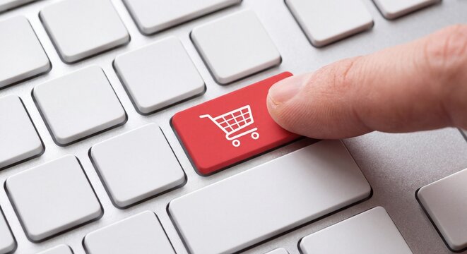 A finger pressing a red button with a shopping cart icon on a computer keyboard with featuring white shopping standard silver computer symbol located standard