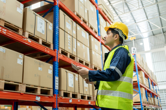 Asian male factory staff check goods in warehouse or inventory and stock product by tablet. Transport logistic business shipping, delivery to customers. inspection, storehouse, storage, factory