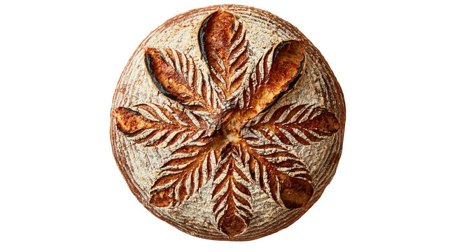 Round sourdough bread loaf with intricate leaf pattern scoring on top crust