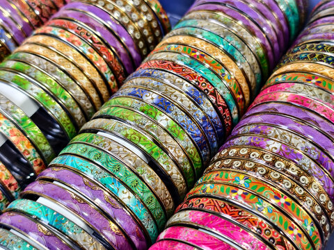 Indian colorful bangles displayed in local shop in a market of Pune, India, These bangles are made of Glass / Lac Bangle used as beauty accessories by Indian women, Selective focus.