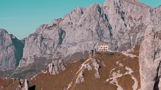 Majestic aerial view of the rosalba mountain refuge nestled among the dramatic rocky peaks of grigna meridionale in the italian alps