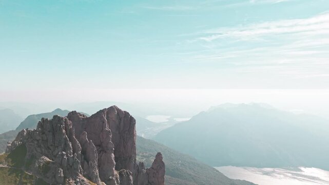 Majestic aerial shot moving over the grigna mountain peaks, revealing a stunning panoramic view of lake como and the italian alps
