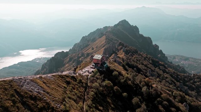 Stunning aerial footage showing the rosalba refuge located on the crest of grigna meridionale mountain, with lake como in the background