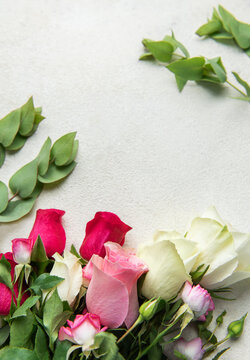Roses and eucalyptus creating floral background with copy space