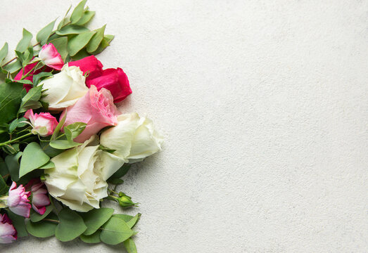 Roses bouquet with eucalyptus leaves on concrete background