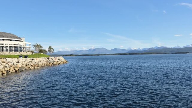Walking video in Molde, Norway, ending with a panoramic view across the fjord toward the distant Sunnmore Alps and the famous landscape of 222 mountain peaks