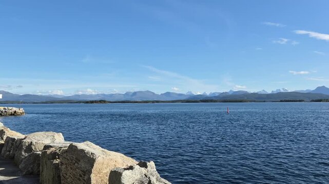 Walking video in Molde, Norway, ending with a panoramic view across the fjord toward the distant Sunnmore Alps and the famous landscape of 222 mountain peaks