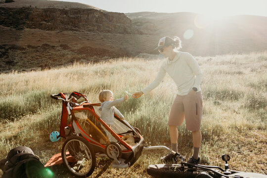 Mother gives her child a flower on a sunny hike
