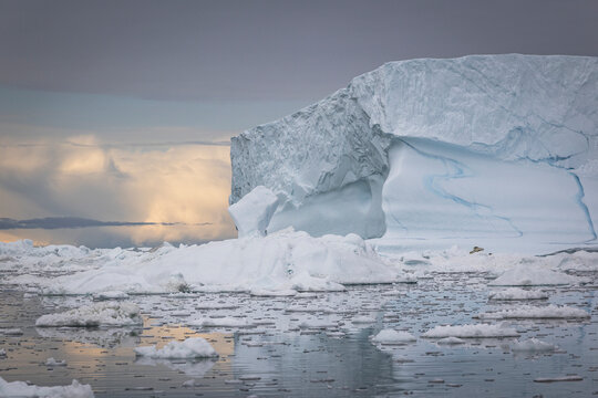 Massive iceberg floating in a vast arctic sea