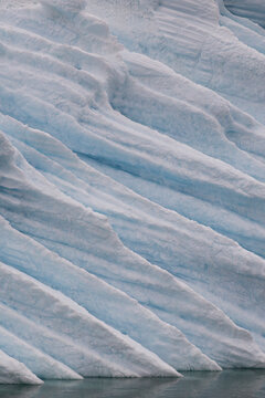 Grooved diagonal textures on a wall of arctic ice
