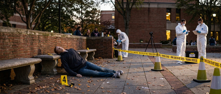 Crime Scene Investigation Forensics team in hazmat suits examining a body marked with evidence tags outdoors