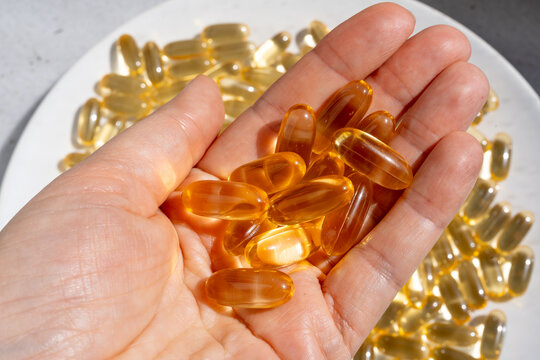 Omega 3 yellow gel capsules, vitamin d bg