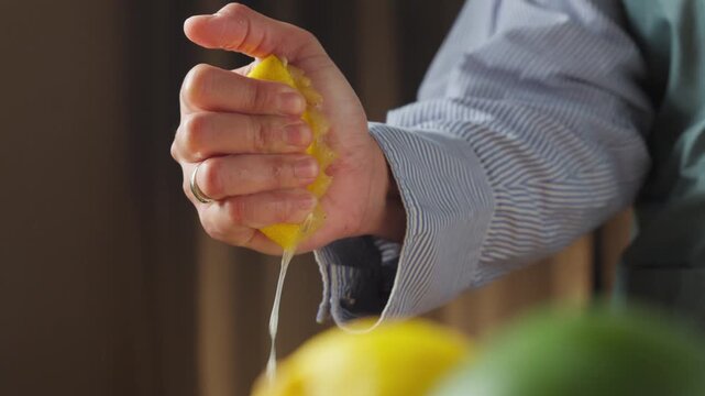 Squeezing a fresh lemon to extract its juice