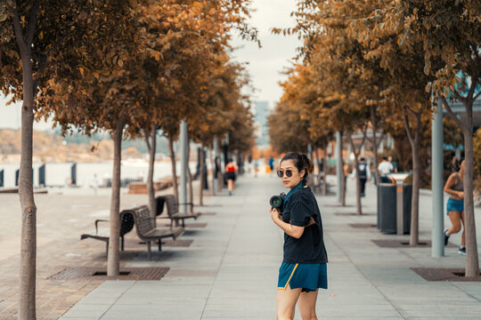 Asian Woman in Sportswear Taking Photos with a Camera in Barangaroo, Sydney, Australia 2 jan 2025