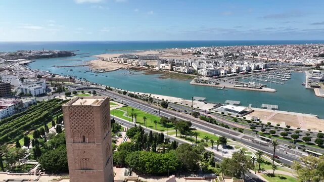 Aerial view of Hassan Tower overlooking the Bouregreg River, marina and Atlantic waterfront, combining Rabat&rsquo;s historic heritage with its modern coastal cityscape.
