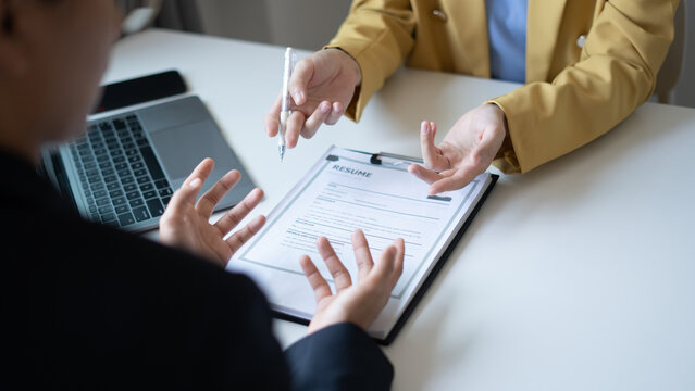 Business people hold a resume and talk to job applicants for job interviews about careers and Their personal history in the company. Recruitment concepts