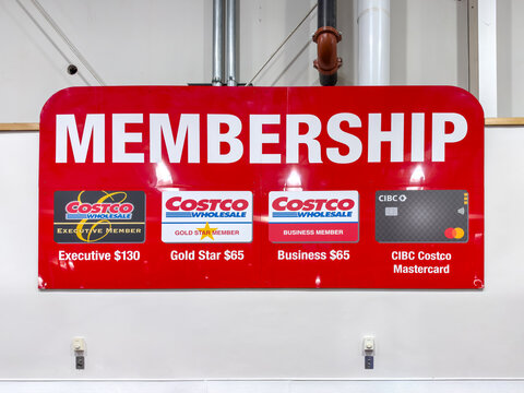 Calgary, Alberta, Canada. October 1, 2026. Red Costco membership sign detailing executive, gold star, business cards and pricing.