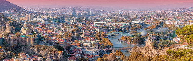 Tbilisi cityscape at sunset, showcasing the Kura River, bridges, Narikala Fortress and Metekhi Church © EdNurg