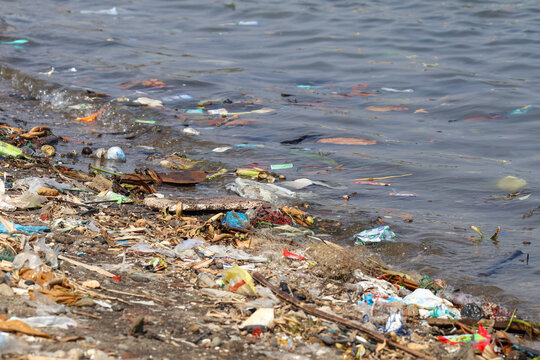 Plastic waste and marine debris polluting a coastal beach in Jepara, Indonesia, highlighting environmental damage, ocean contamination, ecological crisis, and threat to marine life sustainability.
