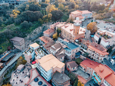 Aerial view capturing historic architecture and colorful rooftops with central Mosque in Old Town Tbilisi, Georgia, during autumn